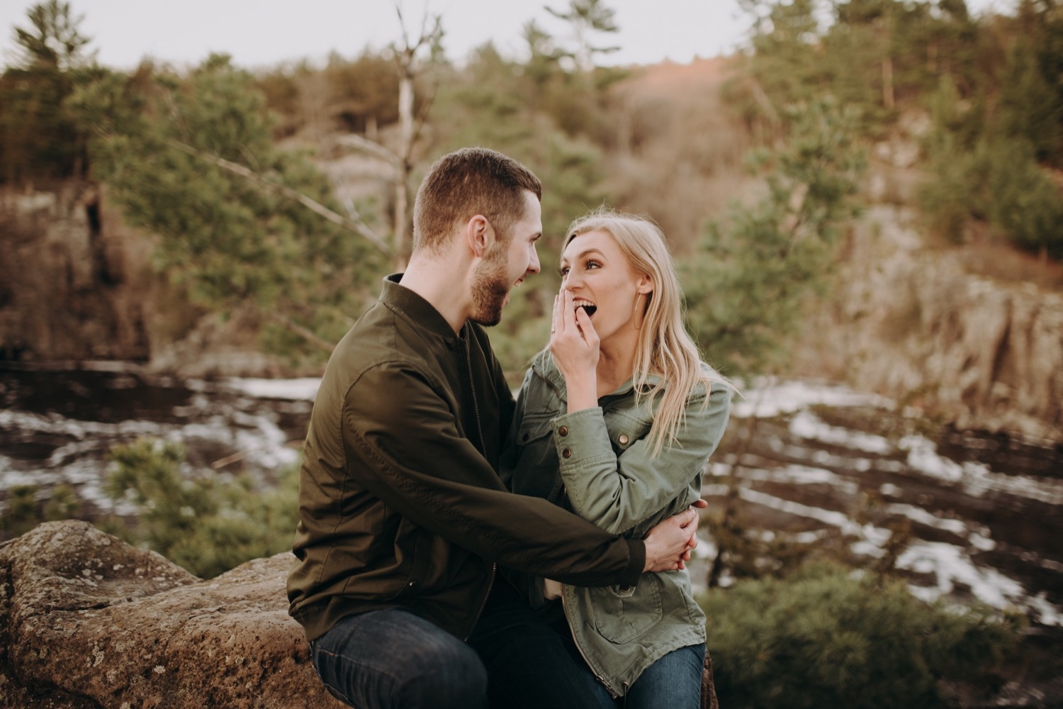 Laughing photos during an engagement session at taylors falls, Minnesota.