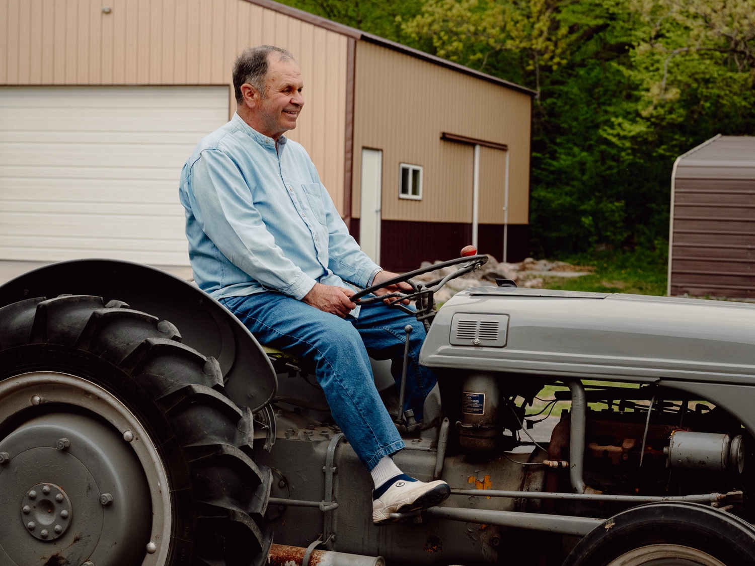 Grandparent Anniversary photos in Buffalo, Minnesota - driving a tractor. 