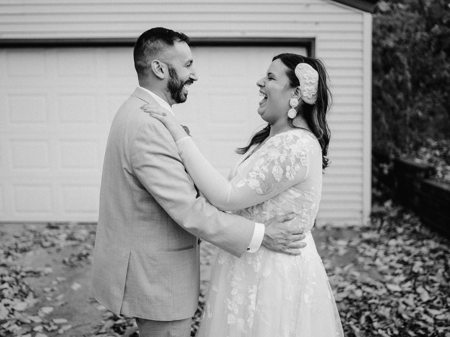 Photos of a bride and groom doing their first dance in their front yard. Fall leaves all over the ground.