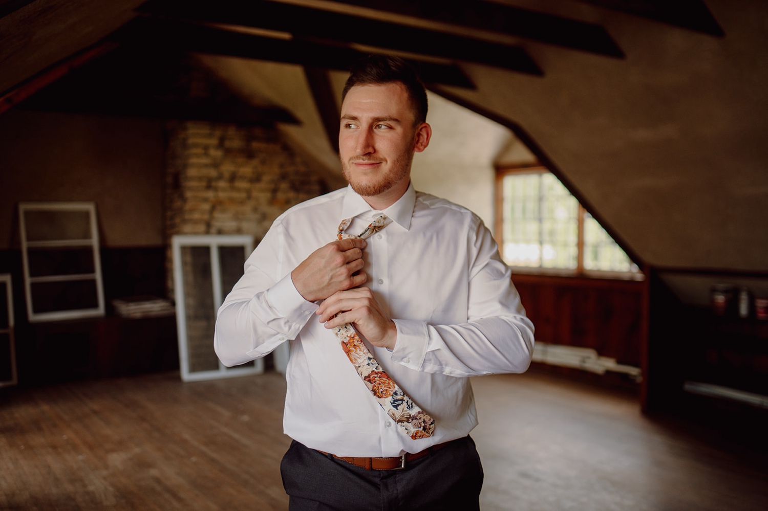 Groom getting ready for wedding at Mayowood Stone Barn in Rochester, Minnesota