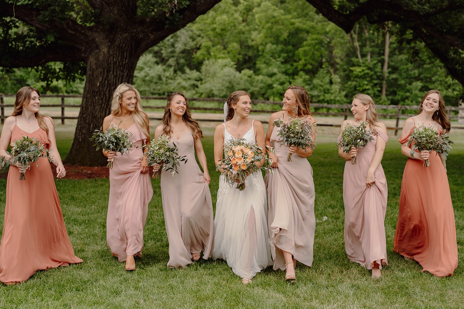 Rust, mismatched bridesmaids dresses. Wedding photos at Mayowood Stone Barn in Rochester Minnesota. 