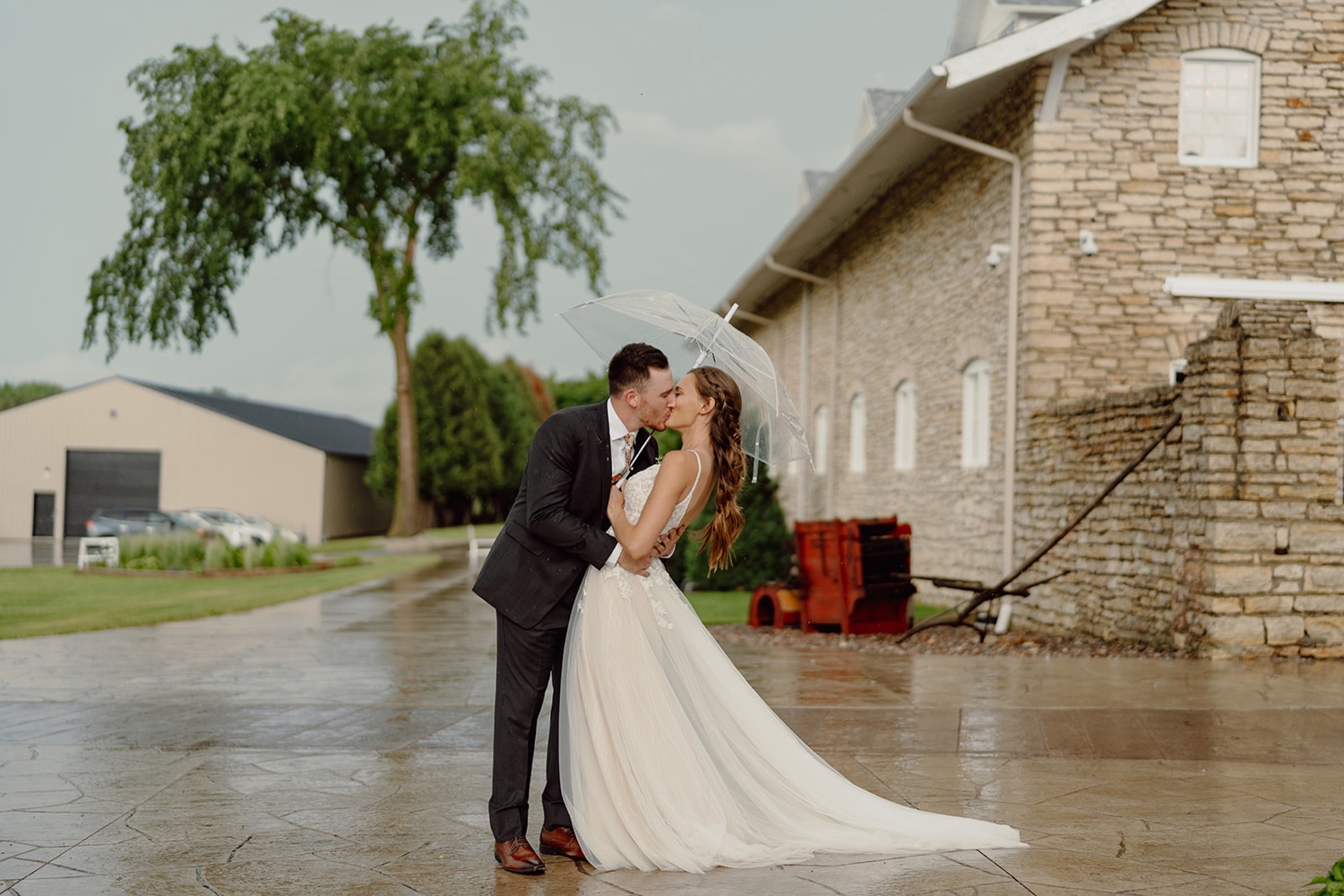 Rainy bride and groom photos at Mayowood Stone Barn in Rochester, MN. 