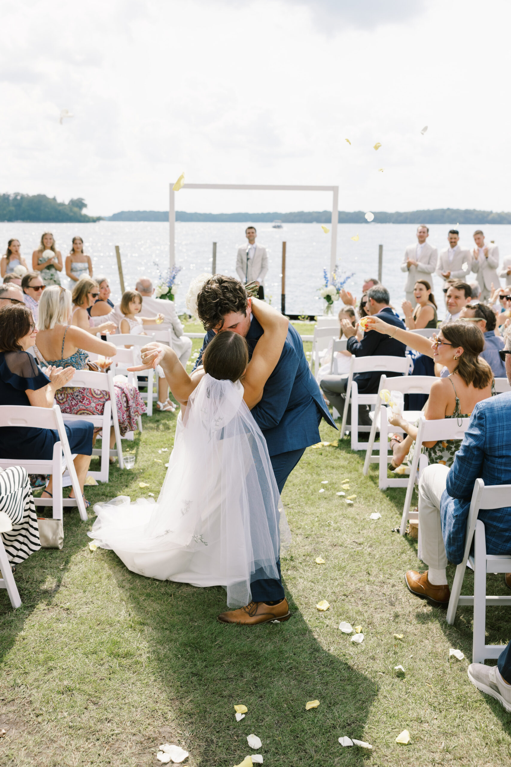 bride and groom kissing in the aisle by Tom Thornton Photography
