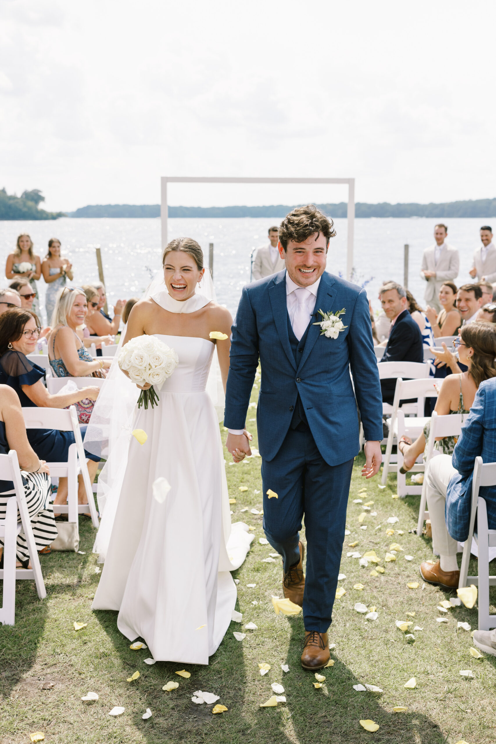 bride and groom walking down the aisle after ceremony at lake minnetonka yacht club
