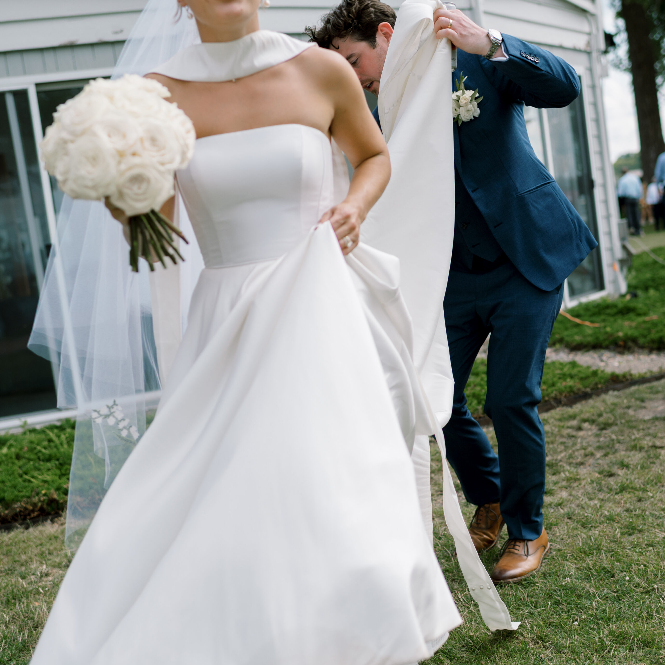 bride and groom walking at minnetonka yacht club wedding
