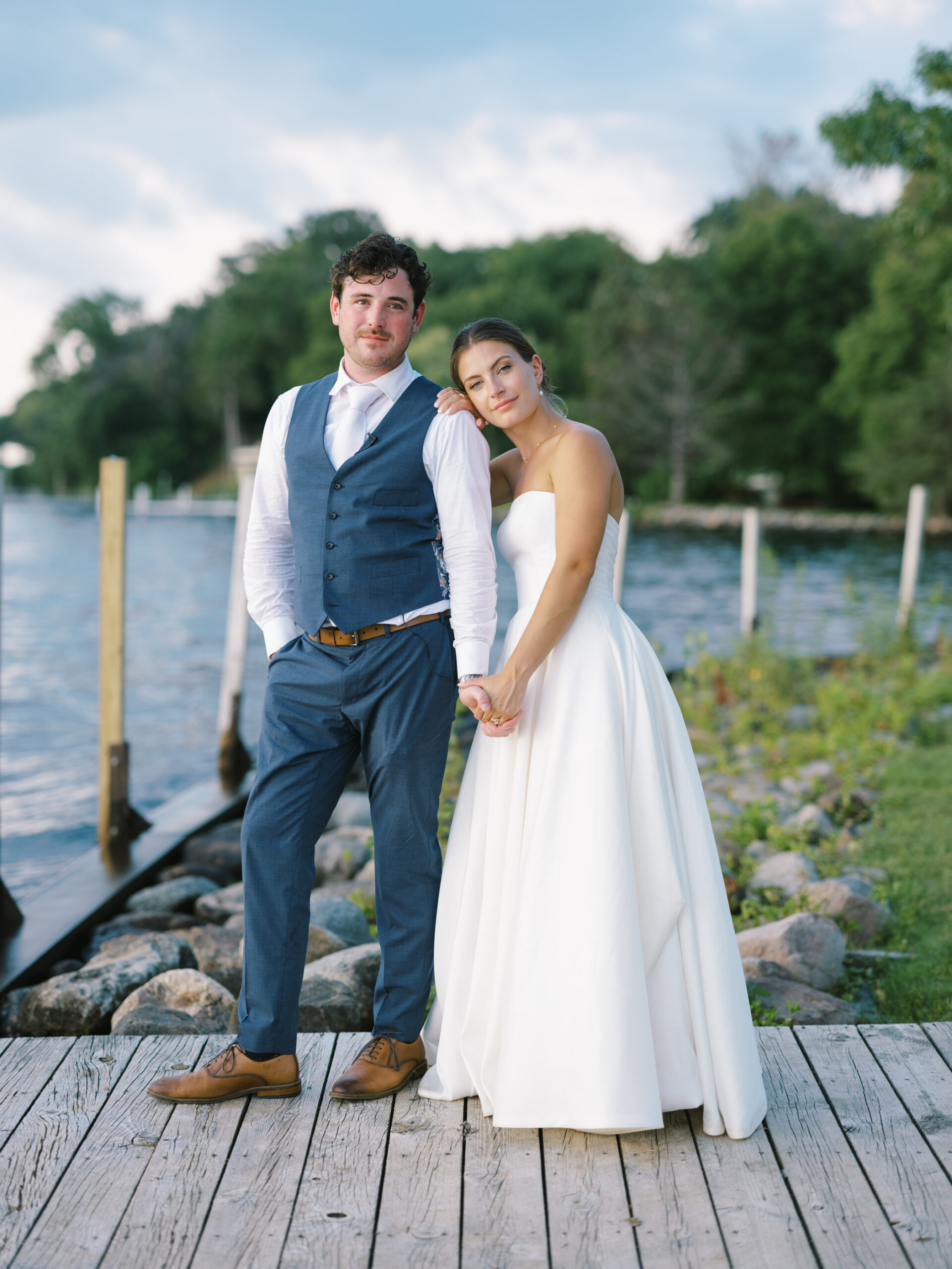 bride and groom smiling at lake minnetonka yacht club
