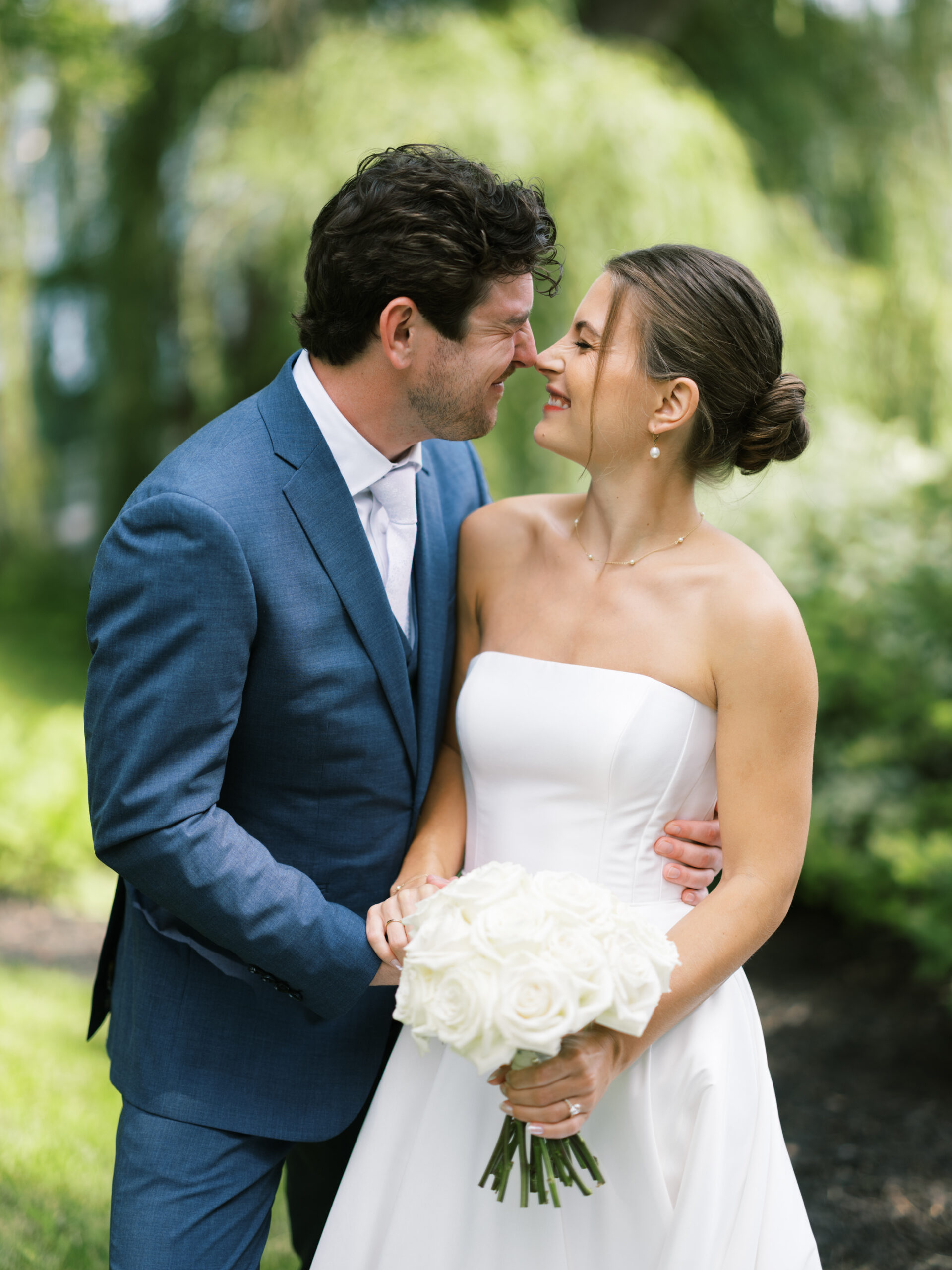 bride and groom touching noses at upper minnetonka yacht club
