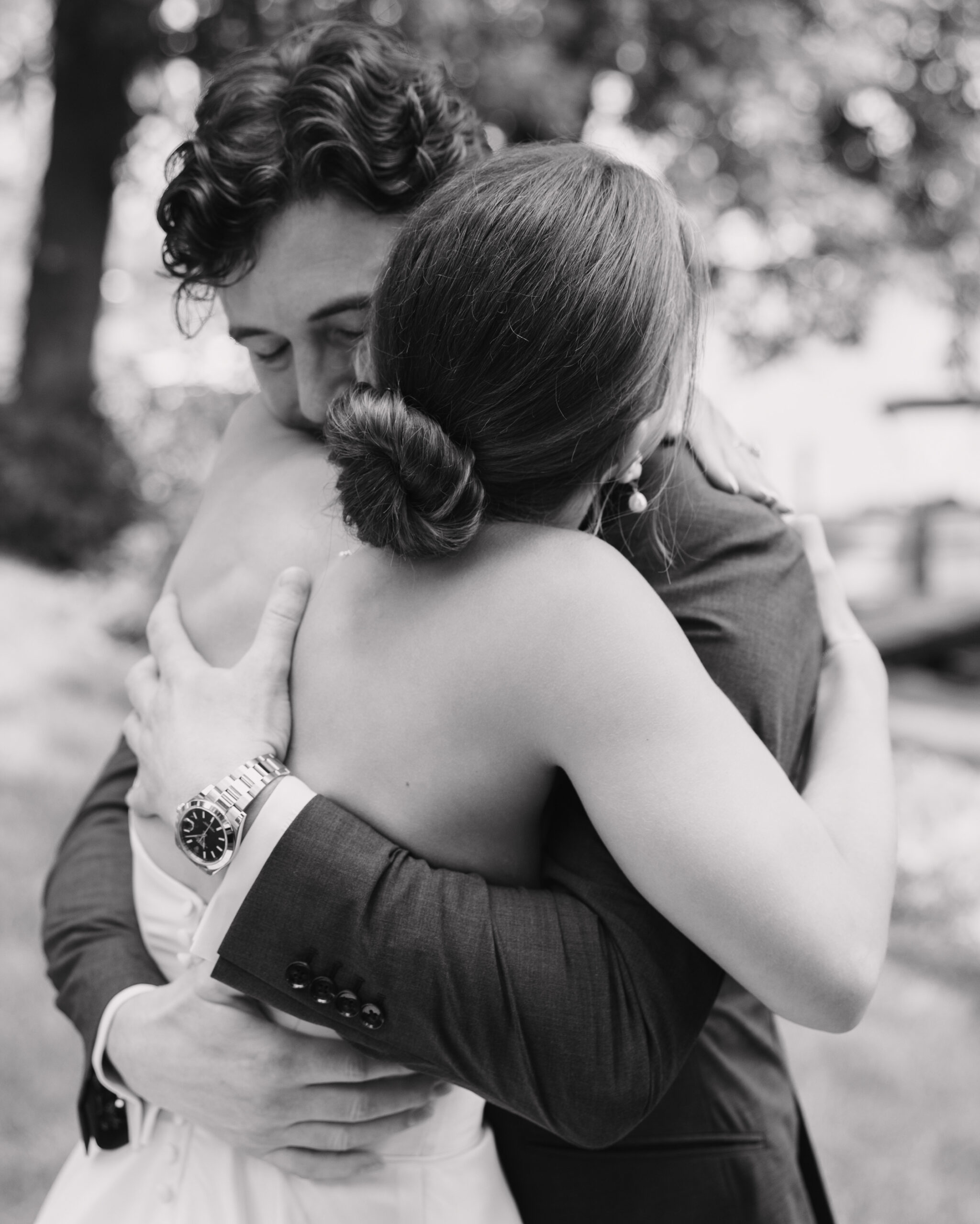 bride and groom hugging at upper minnetonka yacht club wedding