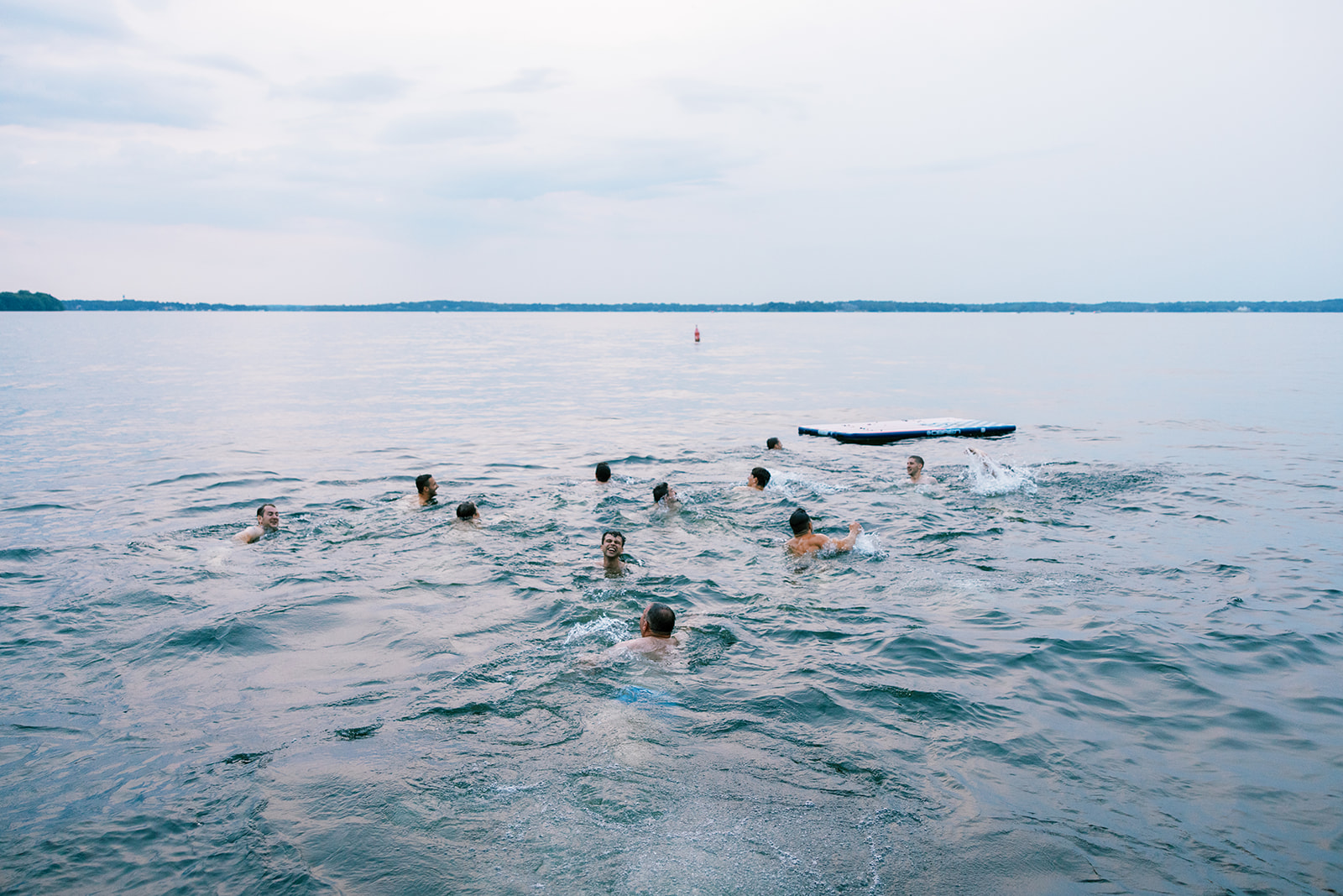 wedding guests swimming in lake at upper minnetonka yacht club