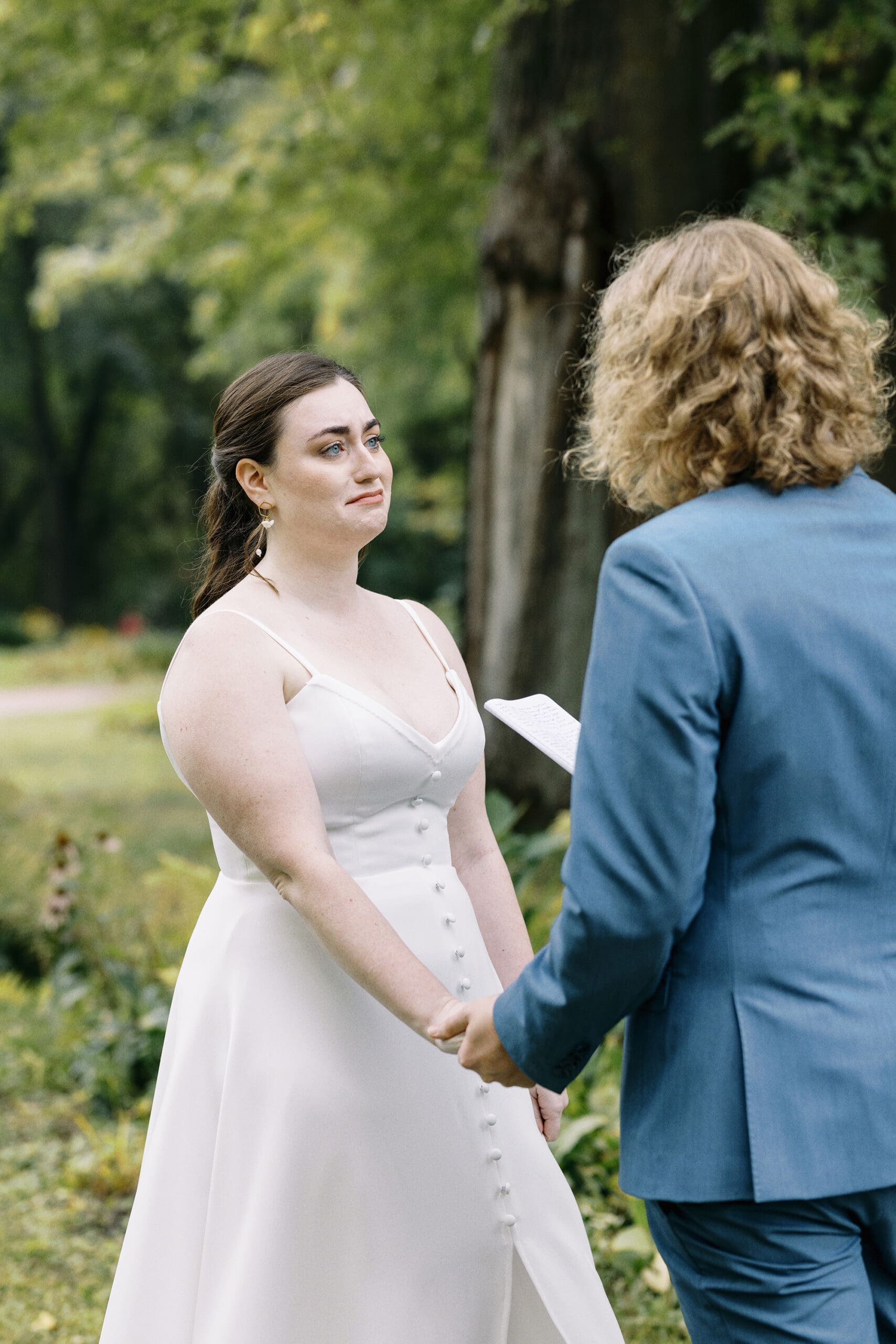 Bride and groom crying during first look portraits outside of the Outing Lodge in Stillwater, MN. 
