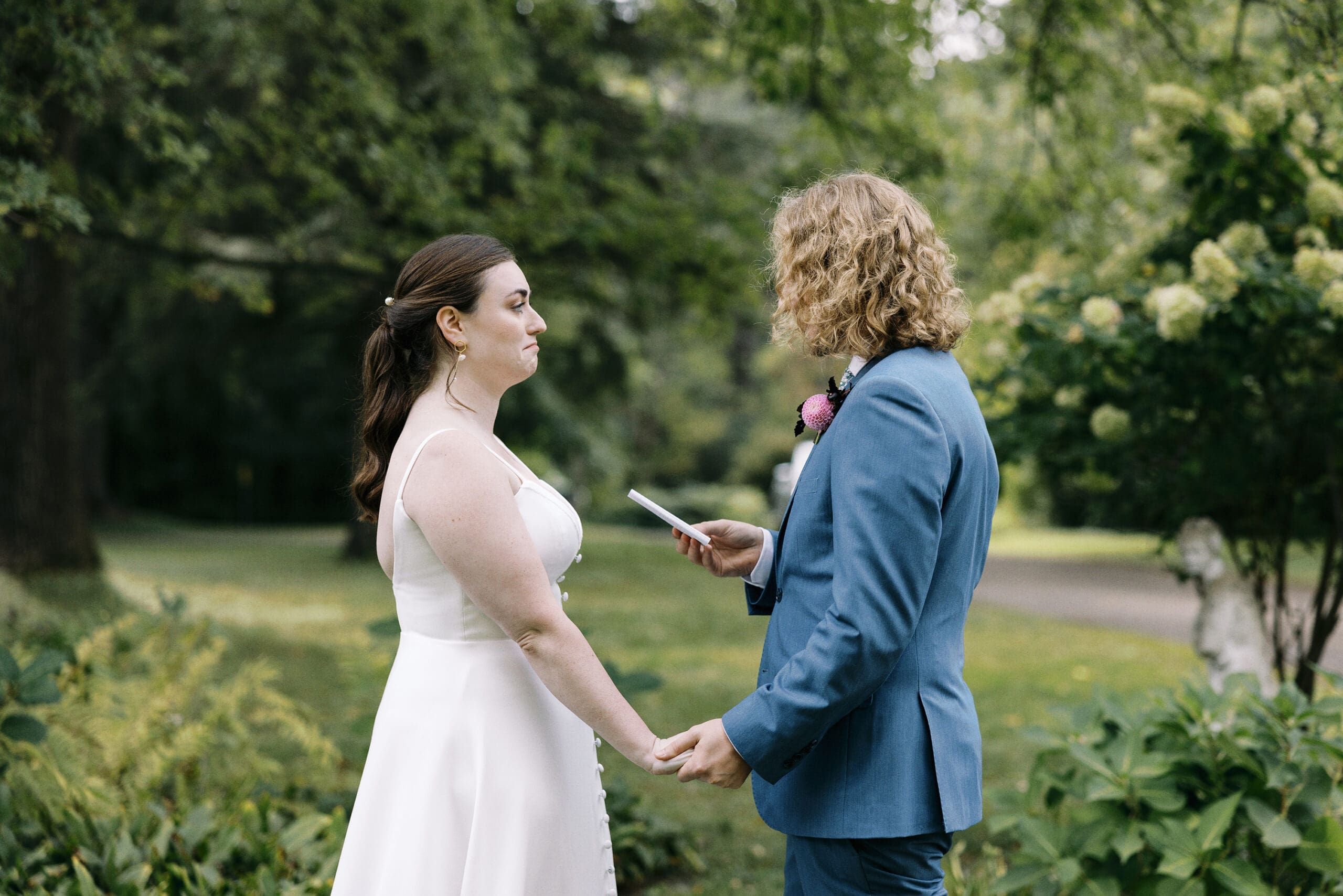 Bride and groom crying during portraits of the vows outside of the Outing Lodge in Stillwater, MN. 