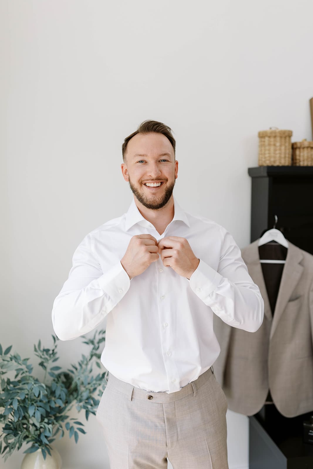 Groom getting ready in the getting ready suite at ivory north co wedding venue.