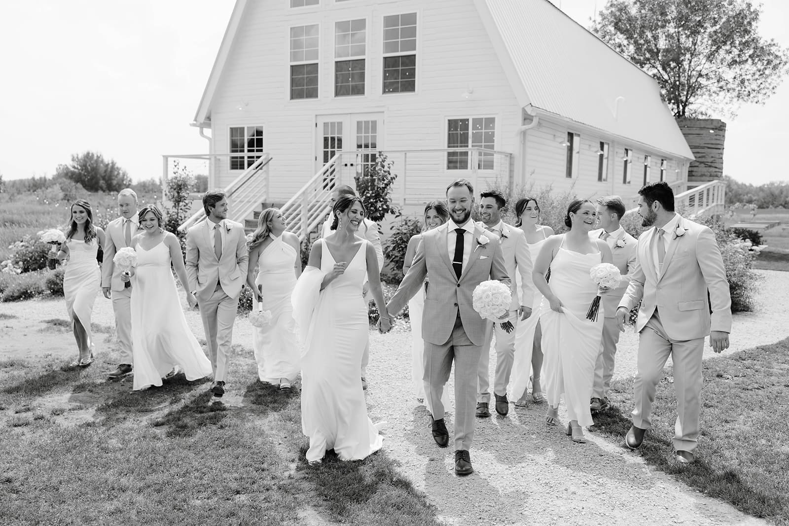 Candid walking wedding party photo at Ivory North venue in Central Minnesota. Photo by Tom Thornton Photography.  