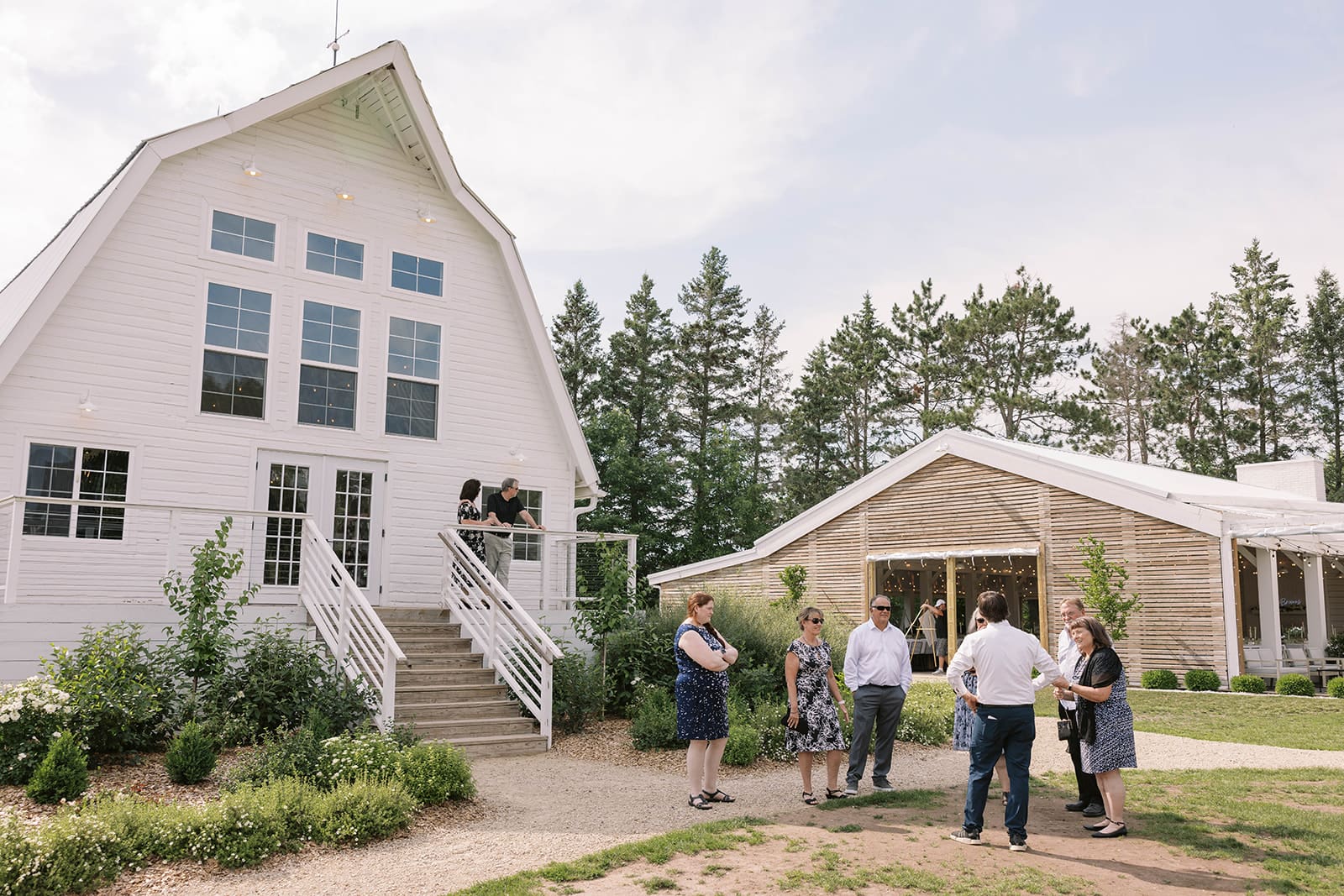 A photo of guests and wedding buildings at ivory North co in the summer. 