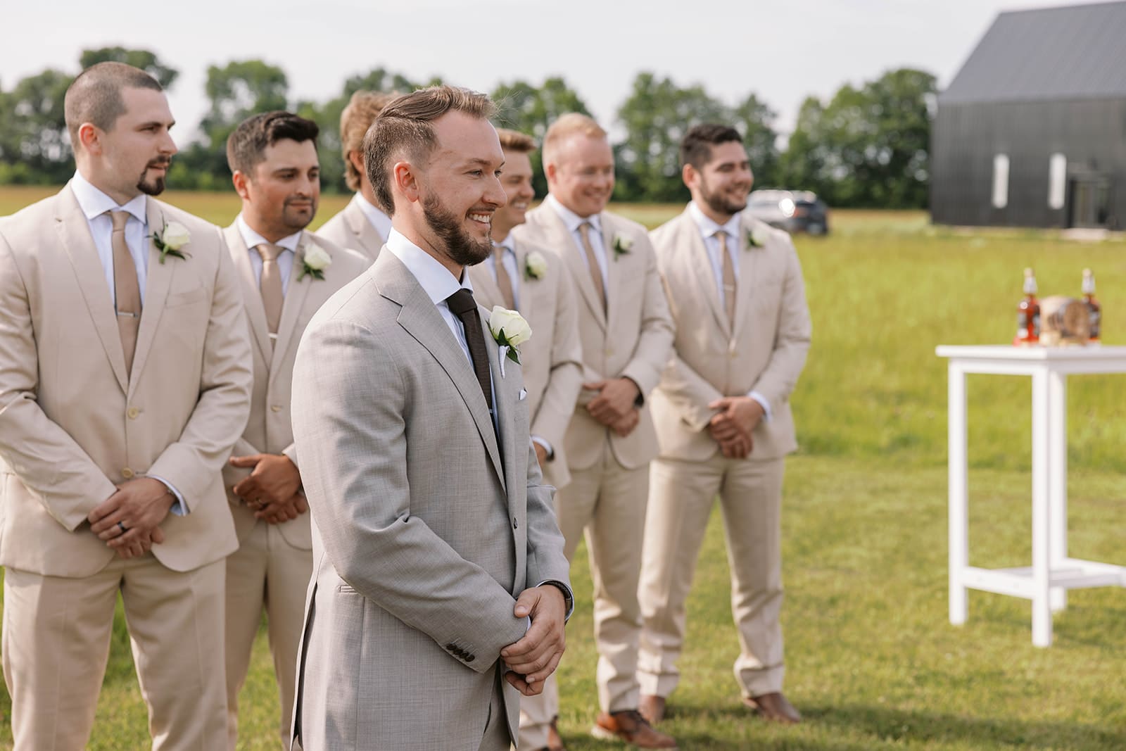 Groom waiting at the end of the aisle as bride walks into the wedding ceremony at ivory North in Minnesota. 