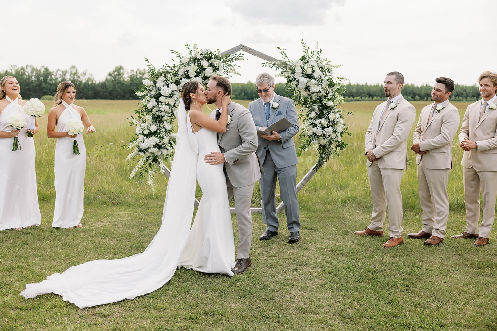 Photo of a Bride and groom kissing at the ceremony in the field at ivory North wedding in Minnesota. 