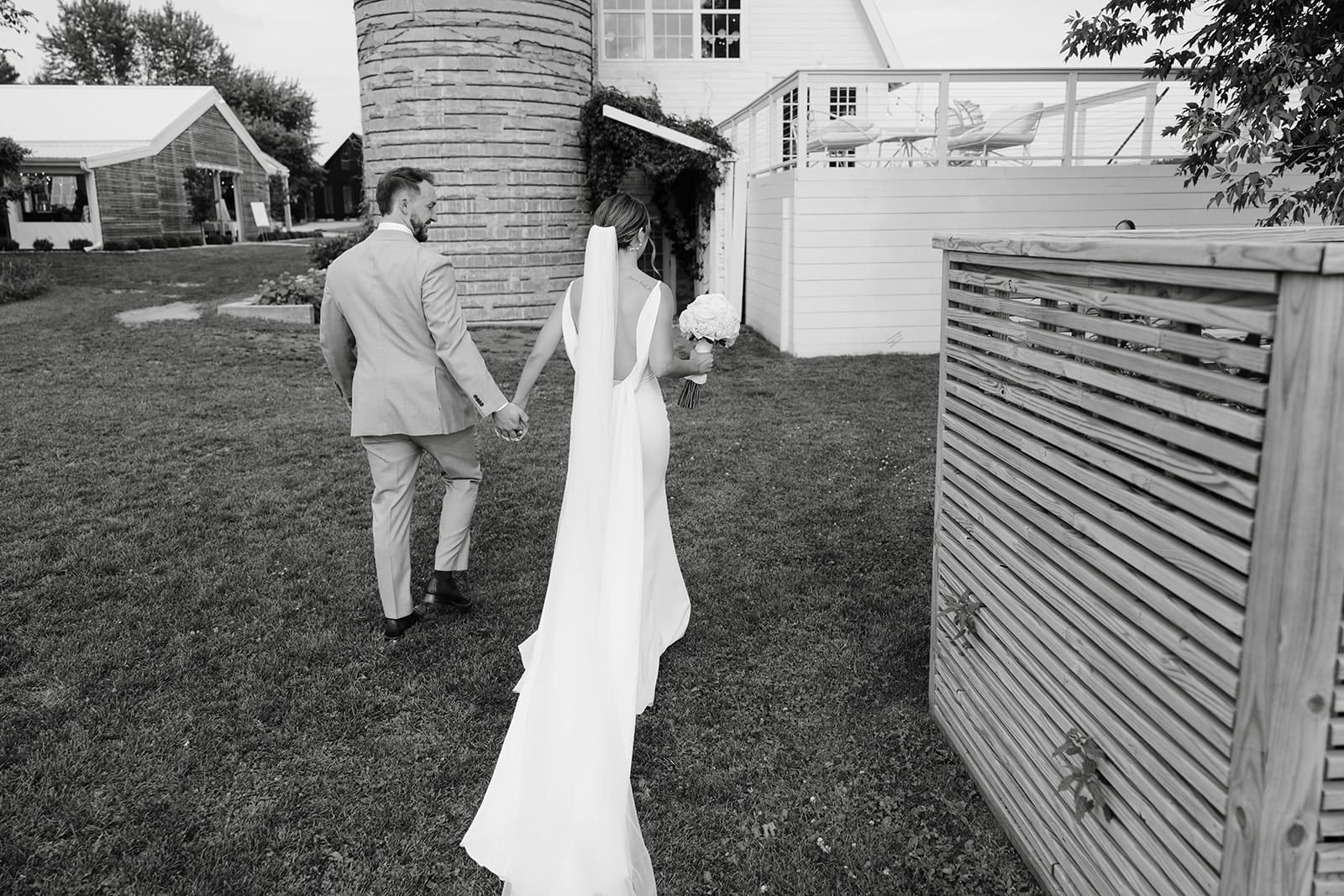 Bride and groom walking holding hands after wedding ceremony at ivory North in Mora,  MN. 