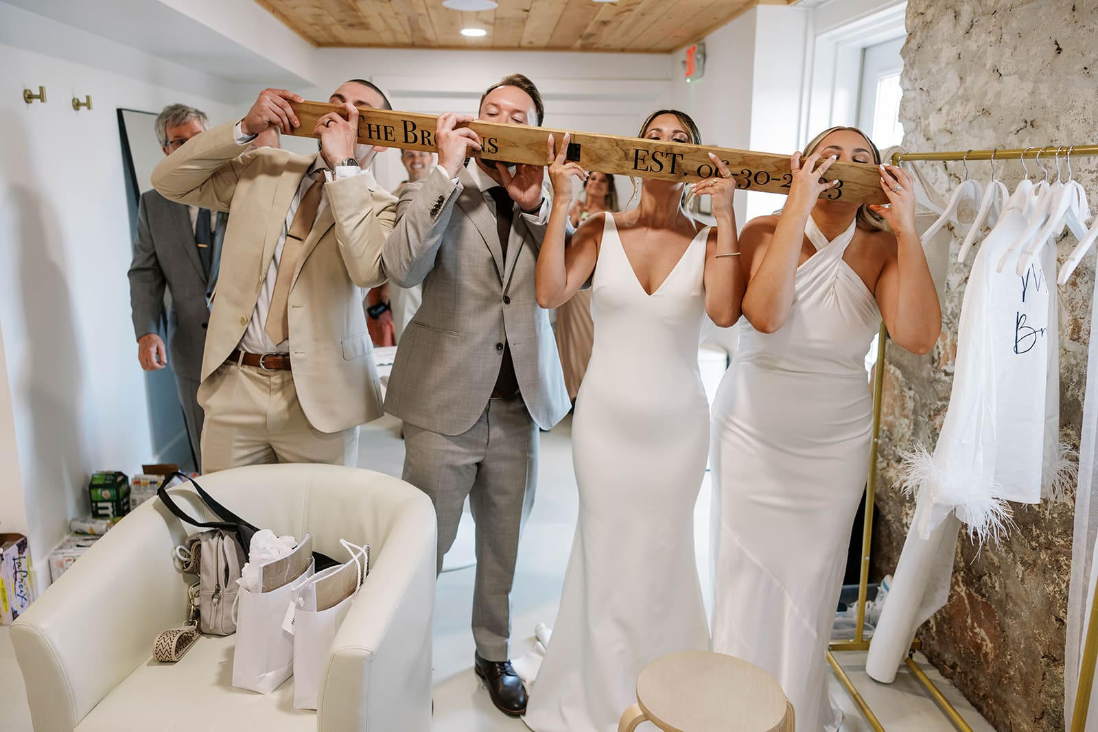 Bride and groom drinking from a shot-ski during candid wedding reception photos. 