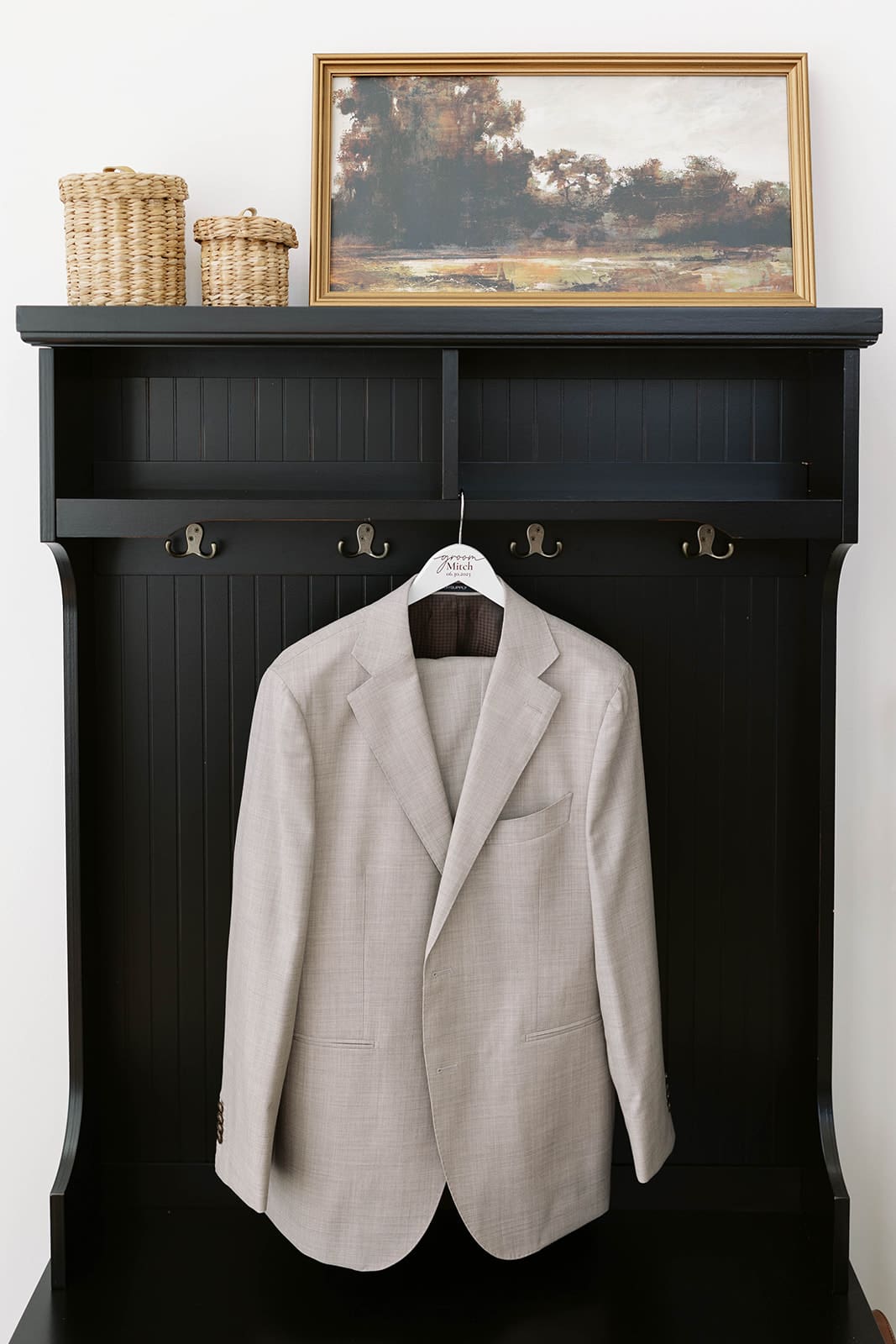 Groom's suit hanging for a detail photo by tom thornton photography. 