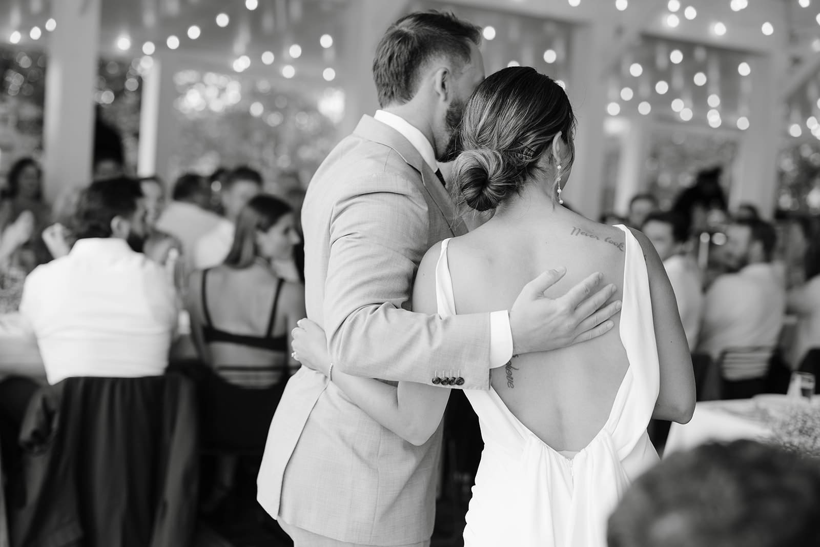 Bride and groom candid hug photo at Ivory North wedding reception in Mora, MN. 