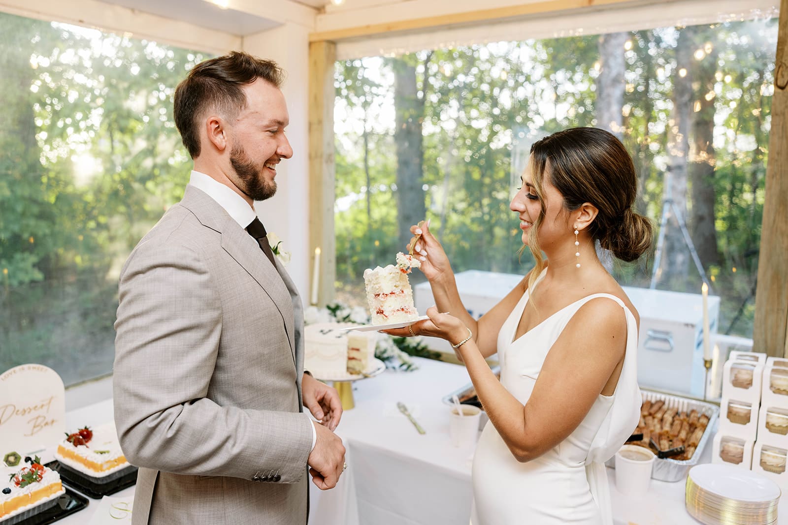 Bride and groom cake cutting portrait during summer wedding at Ivory North wedding venue in Mora Minnesota. Photo by tom Thornton photography. 