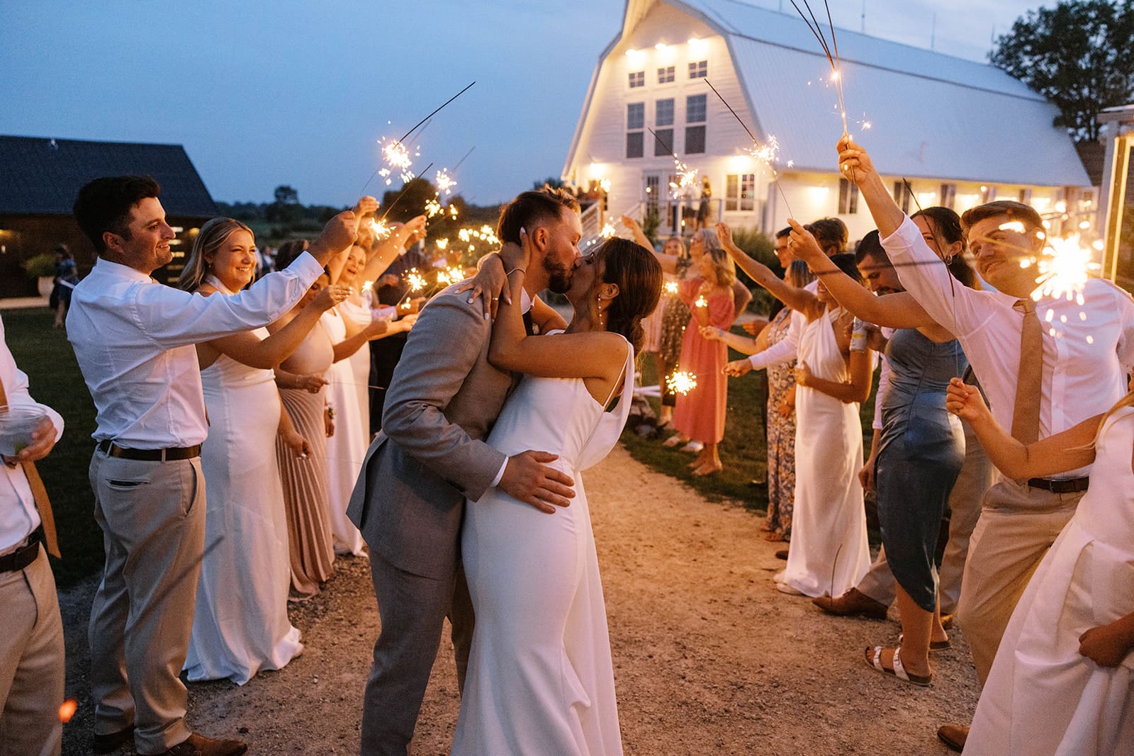 Sparkler exit photos of a bride and groom leaving their summer wedding at Ivory North in Mora, Minnesota.