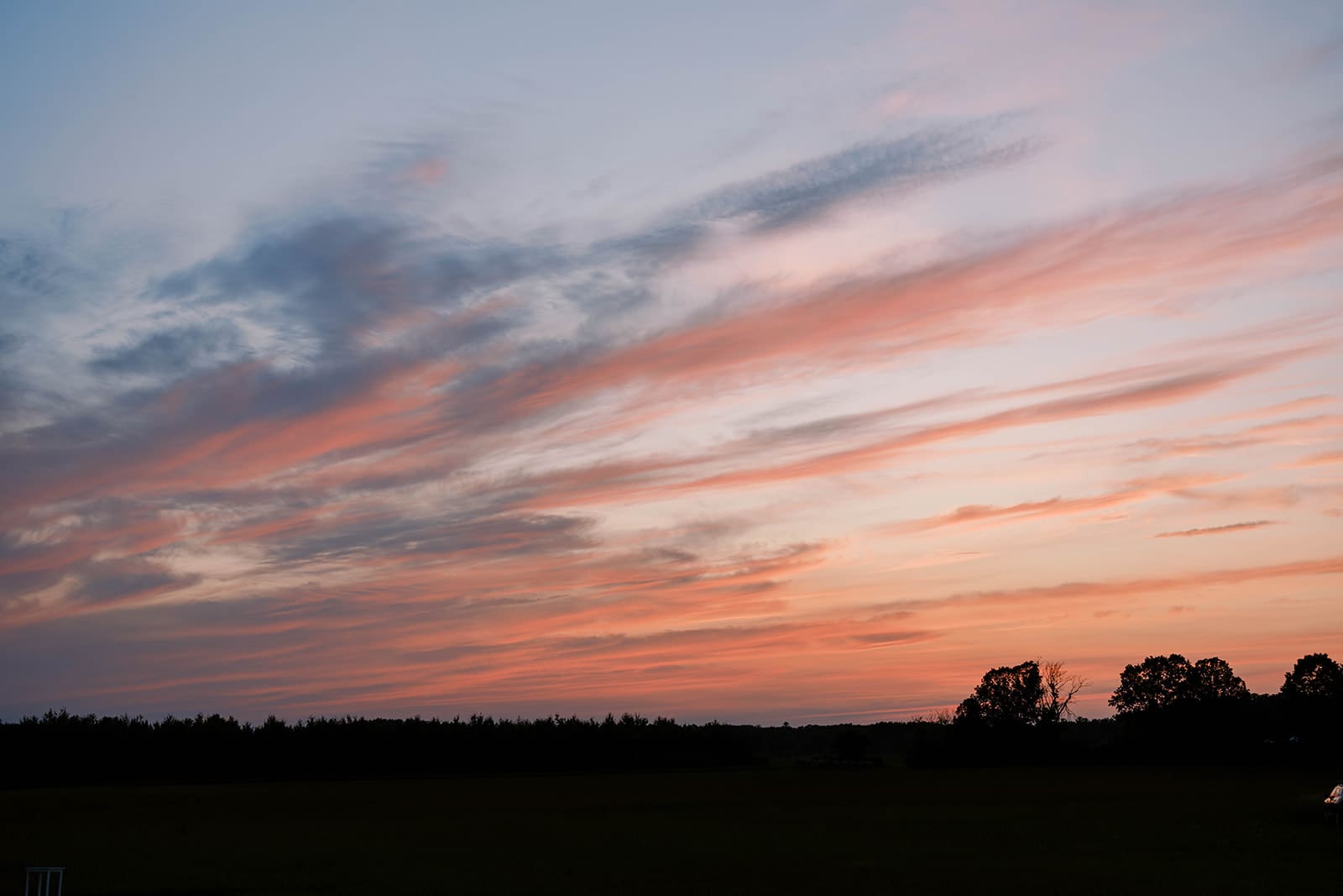 sunset on the field at ivory north wedding venue in Mora, MN, photographed by Tom Thornton.