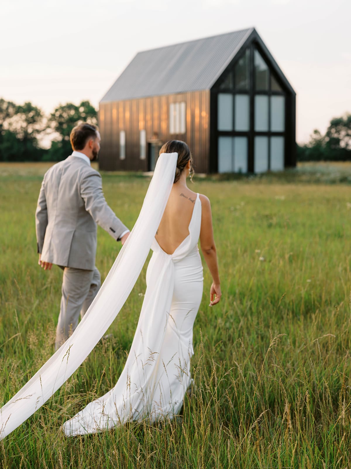 Bride and groom golden hour portraits in the field at Ivory North wedding venue. 