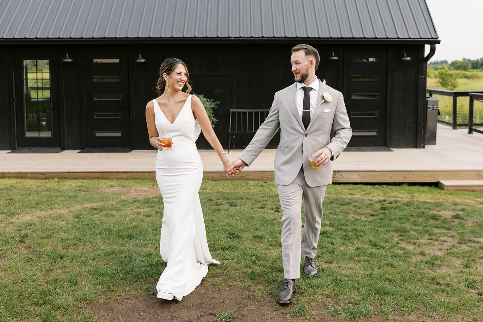 Bride and groom posing for a walking photo during cocktail hour at Ivory North wedding venue by Tom Thornton Photography. 