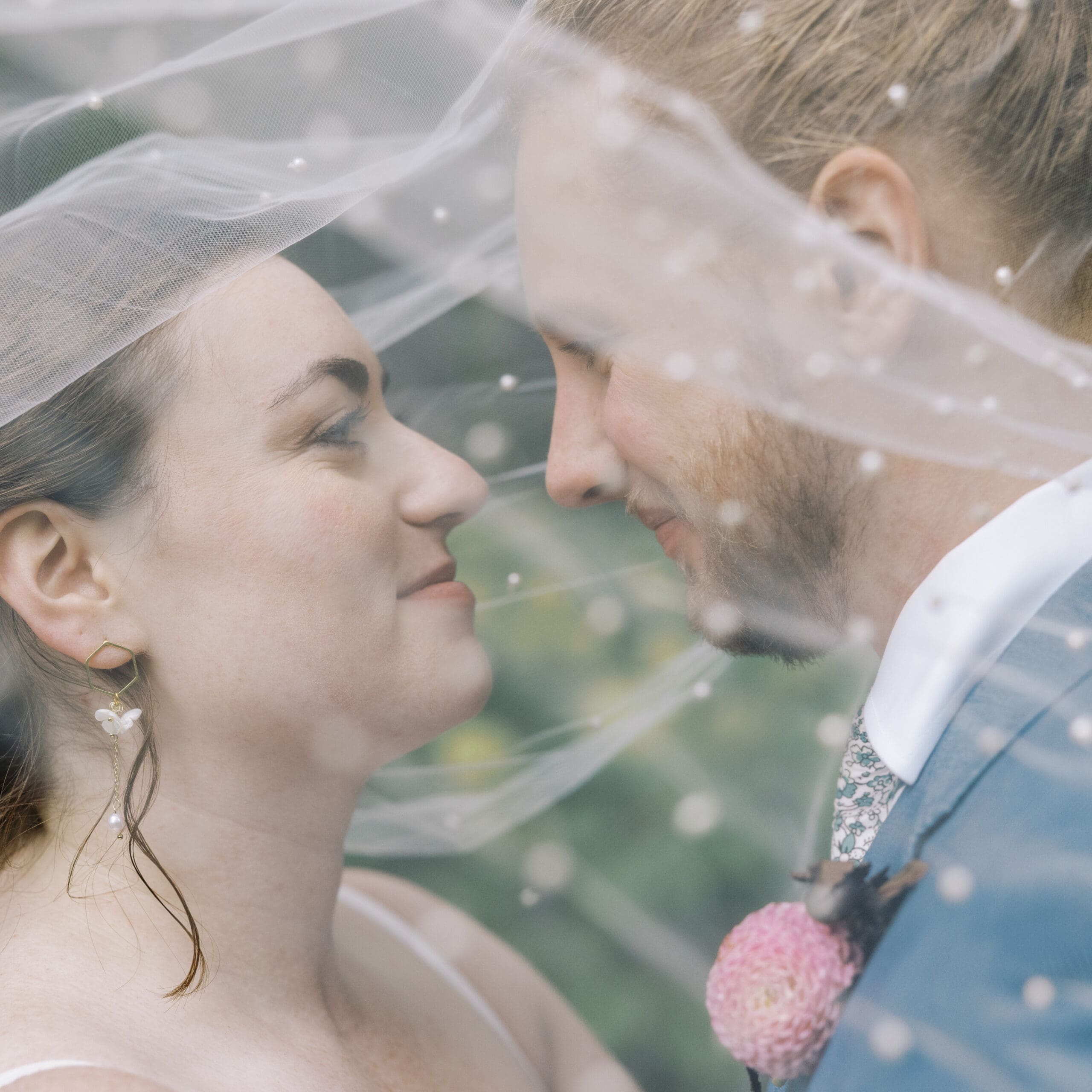 Bride and groom under a veil at their wedding at the outing lodge in stillwater. 