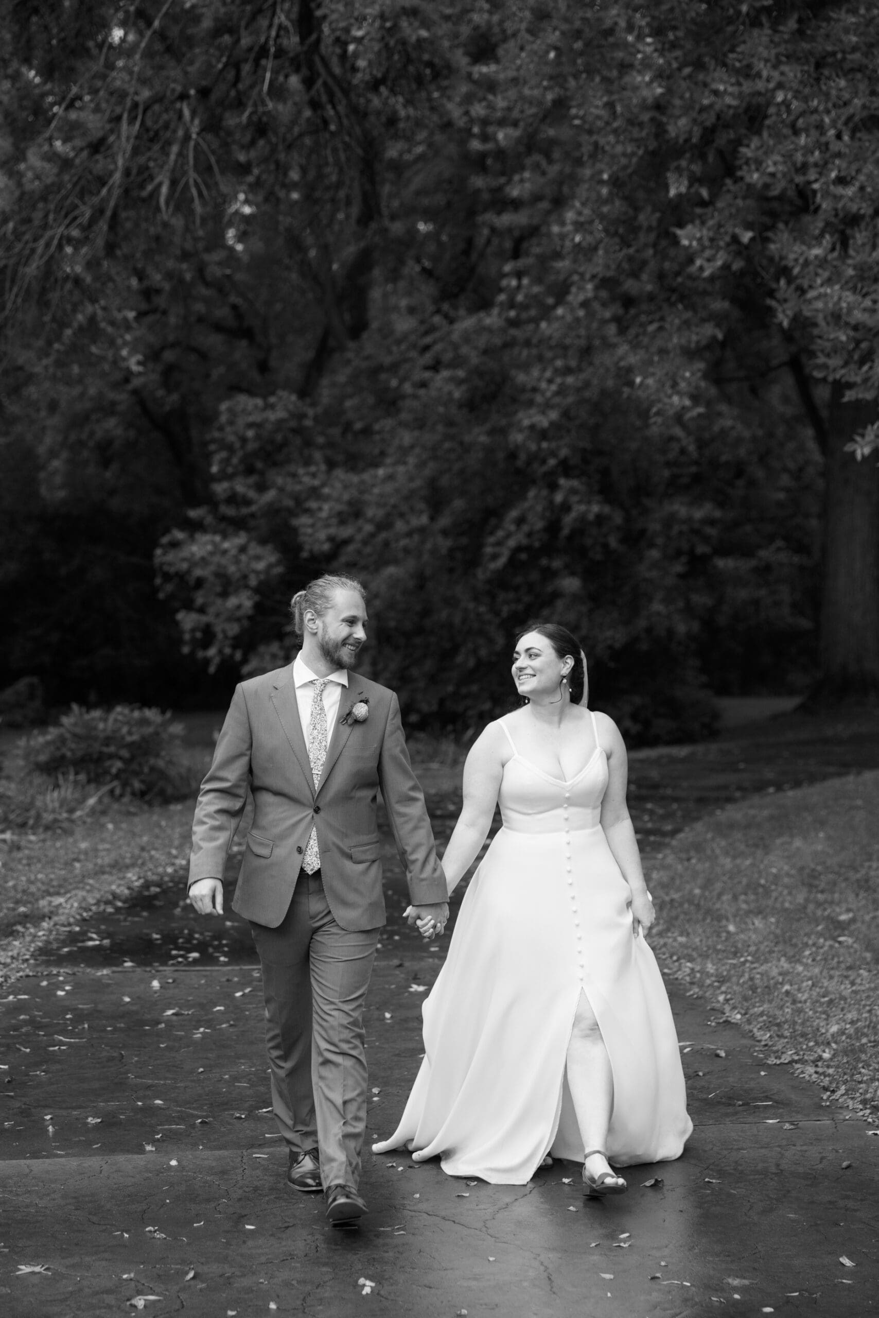 Bride and groom golden hour portraits walking outside of the outing lodge wedding venue. 
