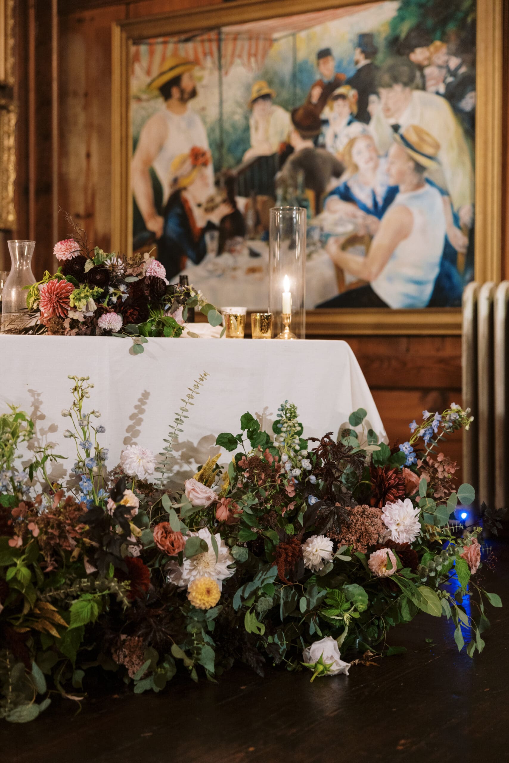 Sweet heart table and wedding florals in front of a classic painting for the wedding reception at the Outing lodge in Stillwater, MN.