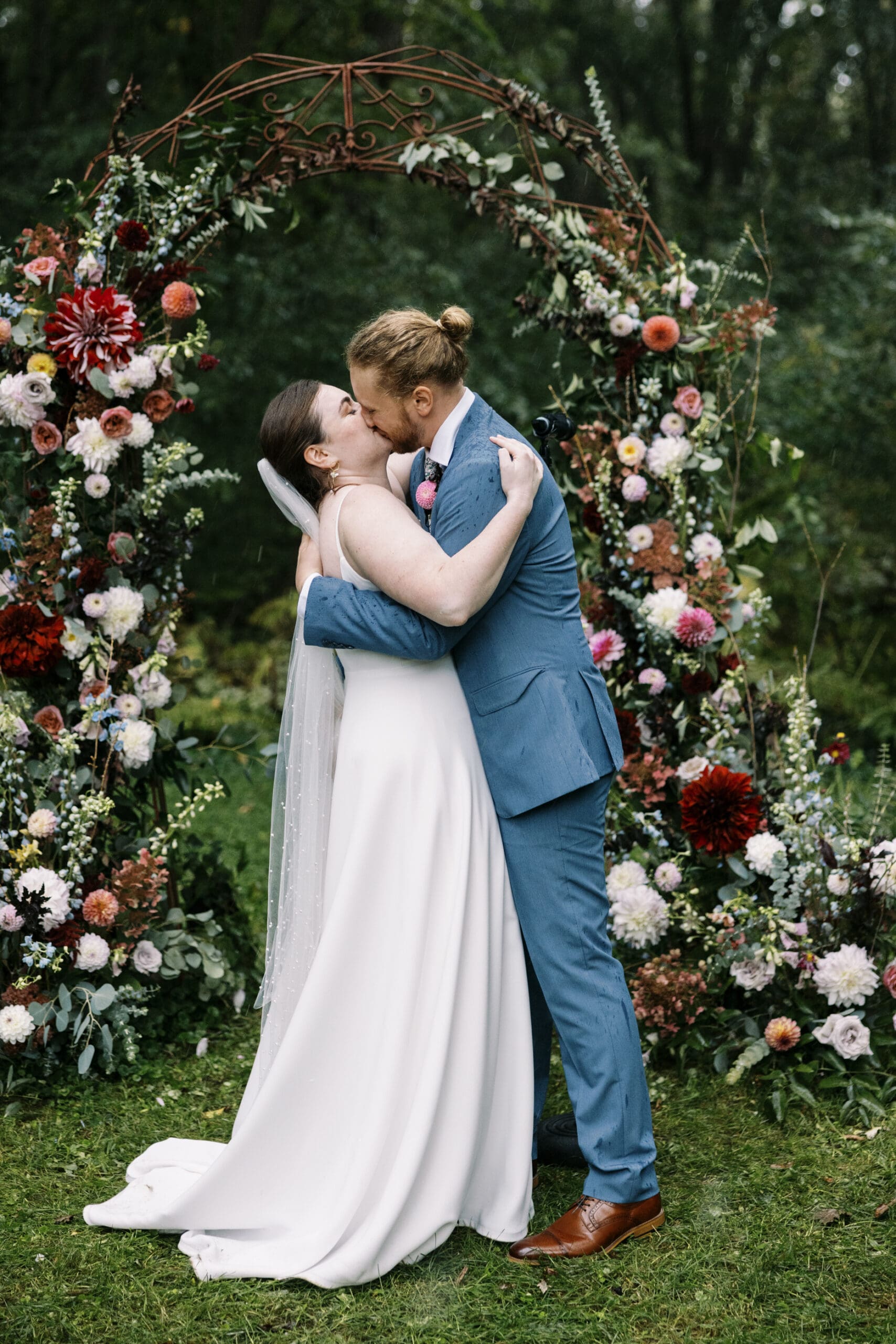 Bride and Groom kissing at their wedding ceremony in the garden at Outing Lodge in Stillwater. 