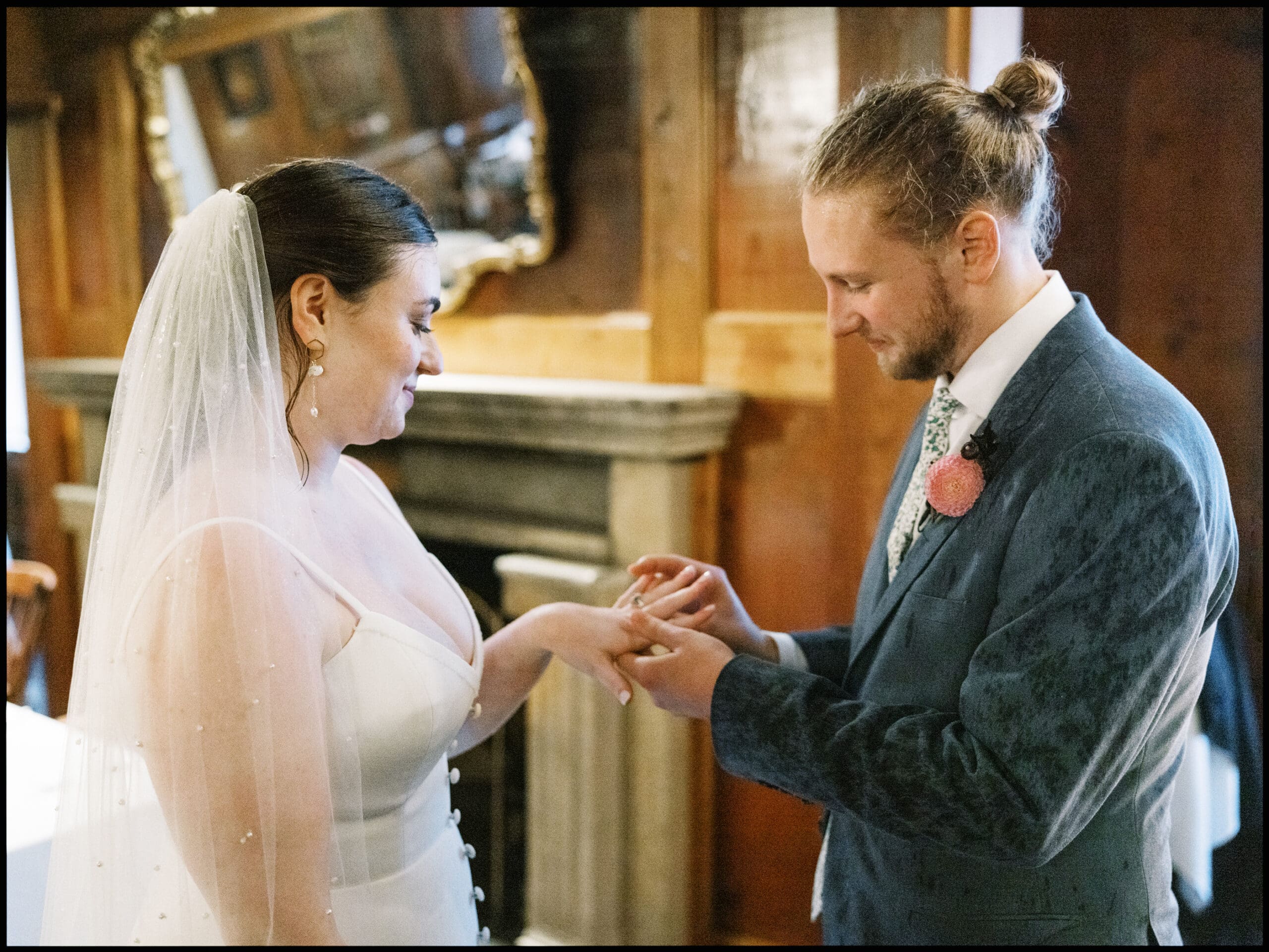 Bride and groom exchanging rings in the outing lodge after their wedding ceremony. 