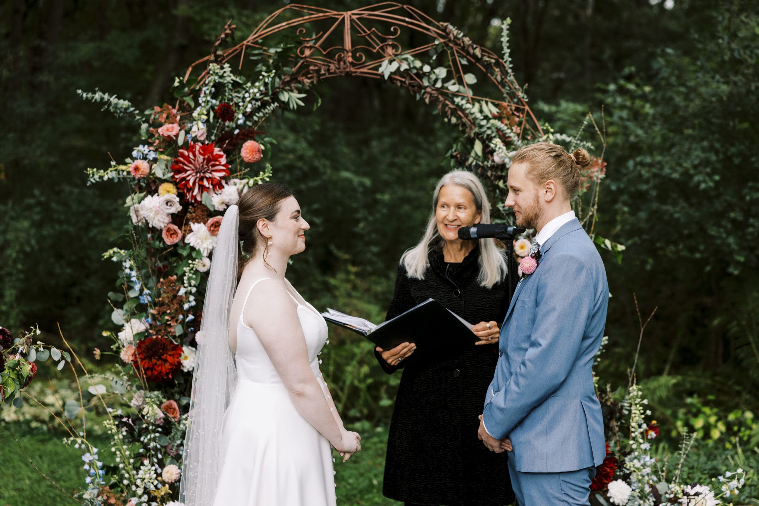 Bride and groom during the rainy garden wedding ceremony at The Outing lodge in Stillwater, Minnesota.
