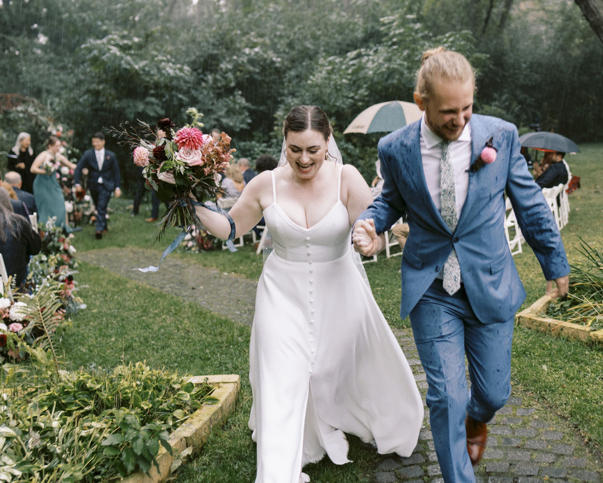 Bride and Groom running out of the rainy wedding ceremony at the Outing lodge in stillwater, MN. 