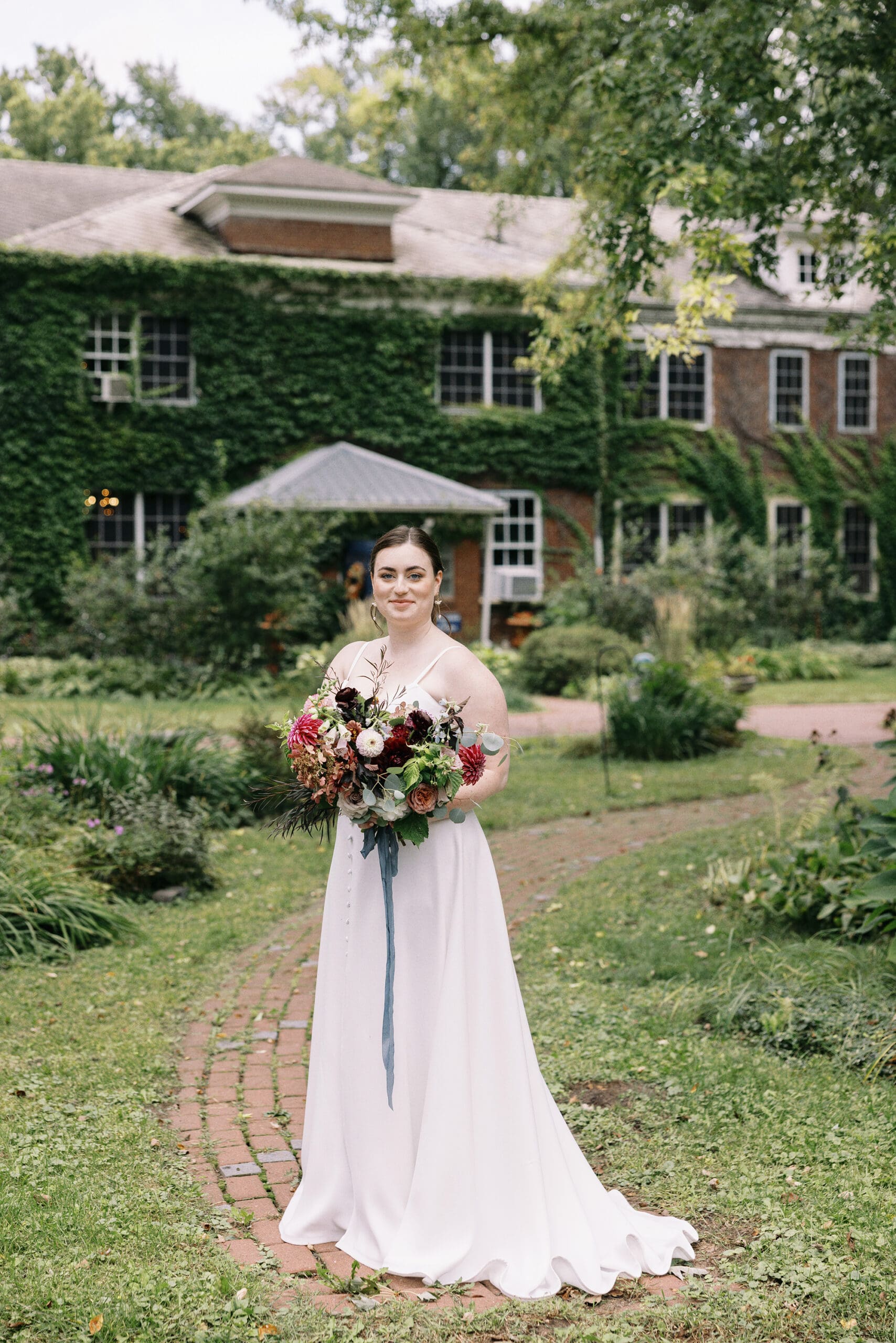 Bridal portrait outside the front of the outing lodge wedding venue in stillwater, MN. 