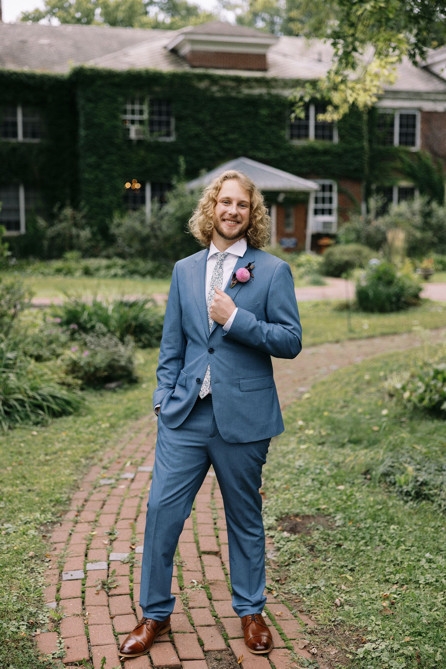Groom portrait outside the front of the outing lodge wedding venue in stillwater, MN. 