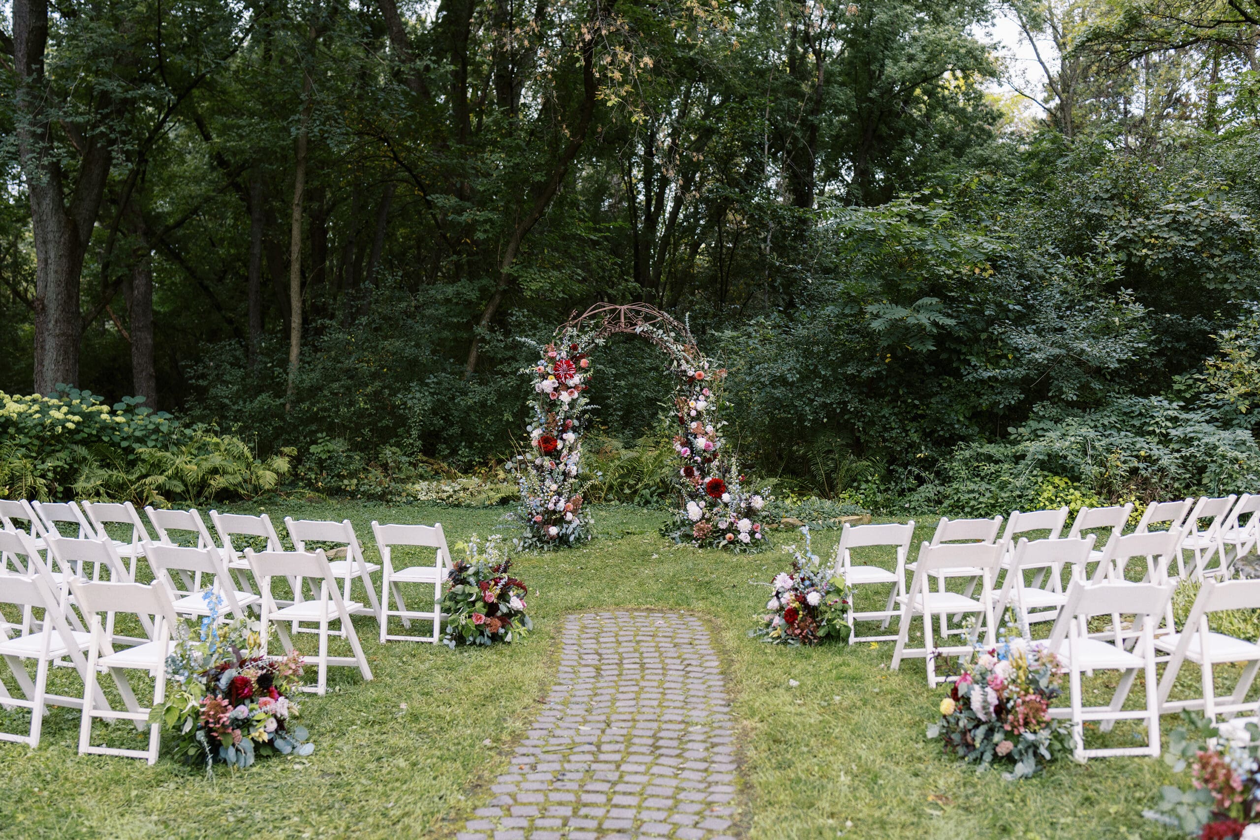 Flower arch Garden wedding ceremony at The Outing Lodge in Stillwater, MN. 