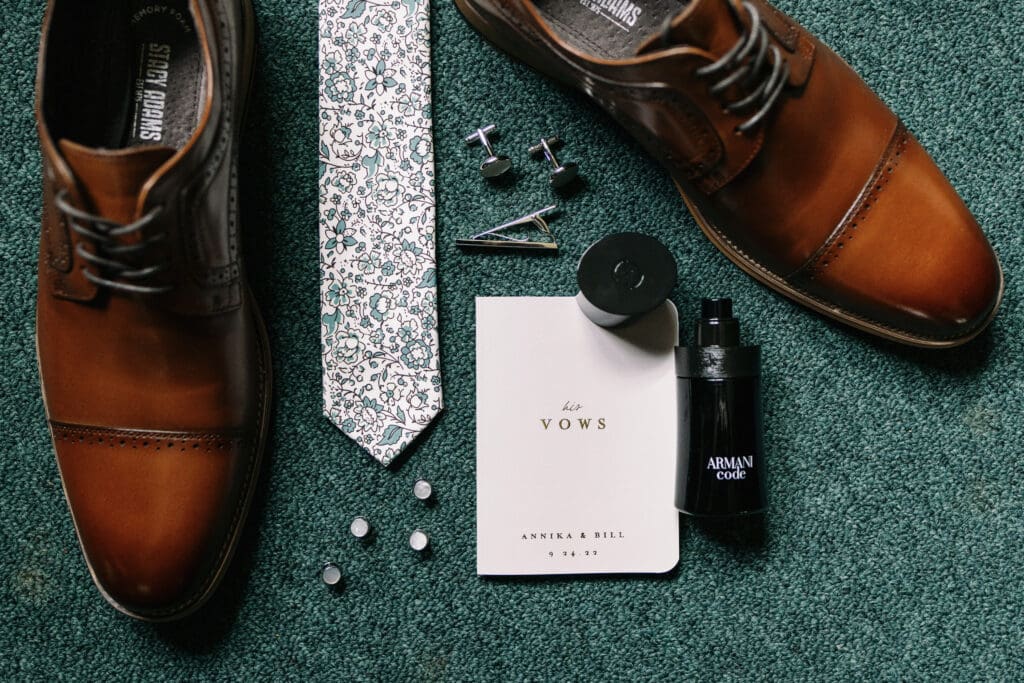 The groom's wedding getting ready details displayed on the floor at The Outing Lodge.