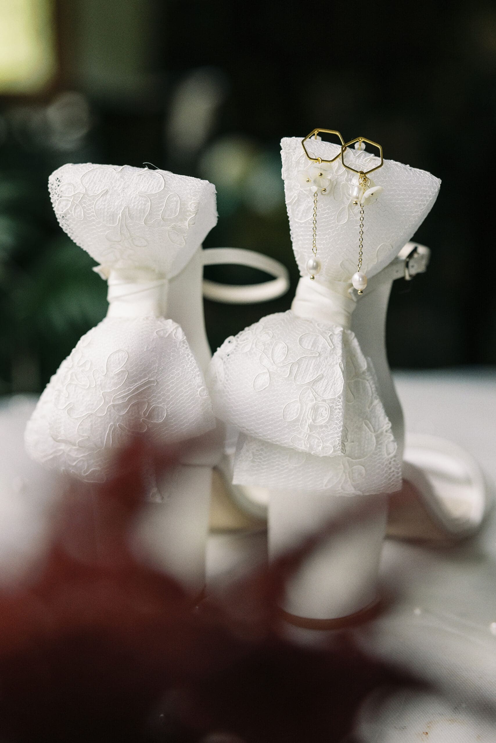A close-up photo of the Bride's wedding shoes and jewelry at The Outing lodge in Stillwater, MN.  