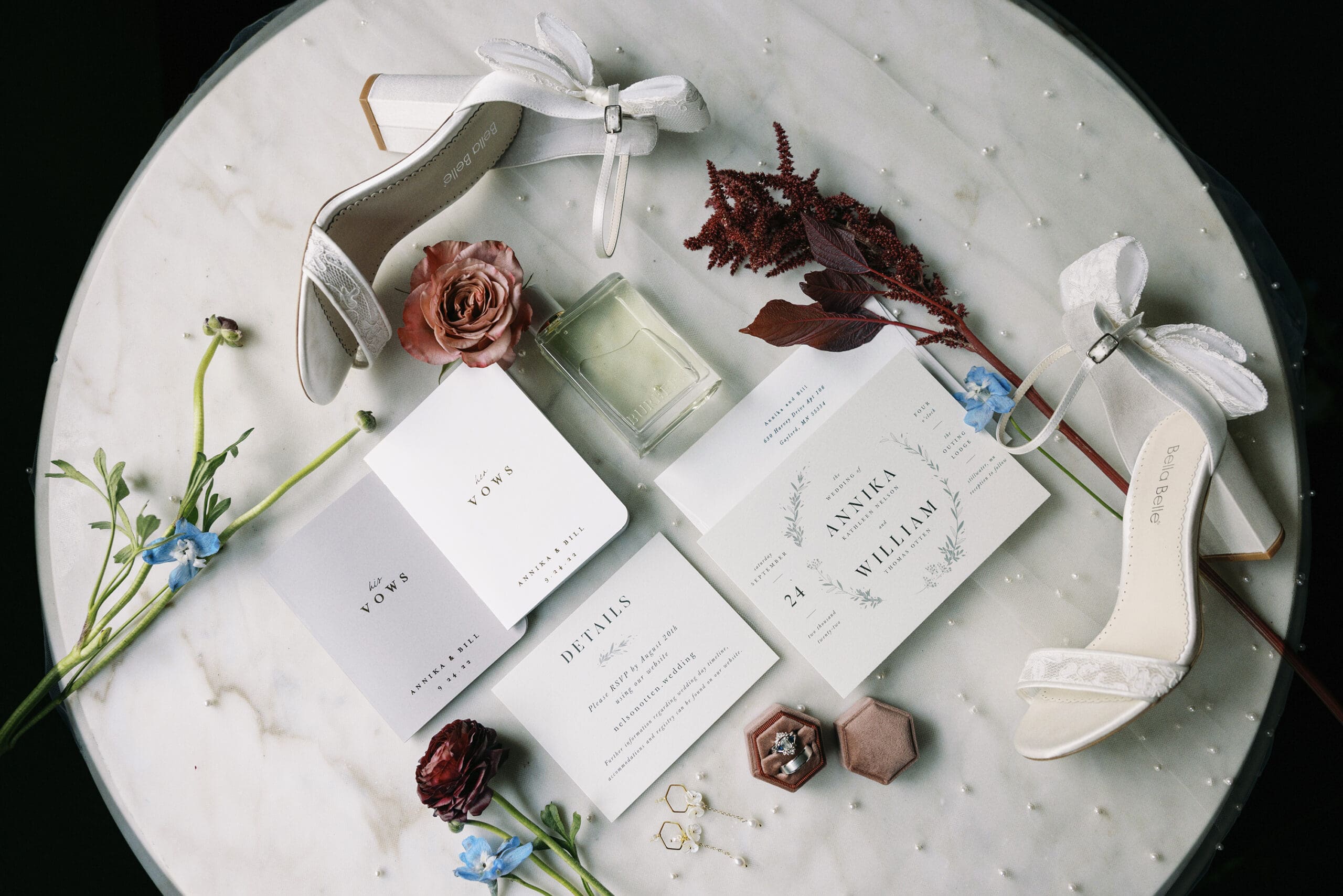 Brides getting ready wedding details displayed on a marble table at The Outing lodge in Stillwater, MN.  