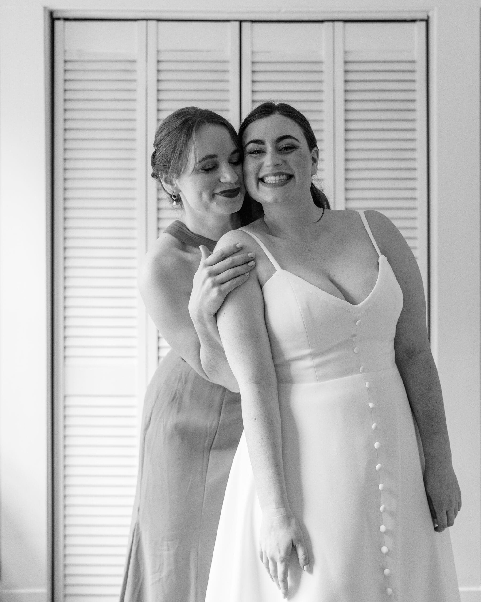Bridal portrait while getting ready with family in the morning in The Outing Lodge hotel room. 