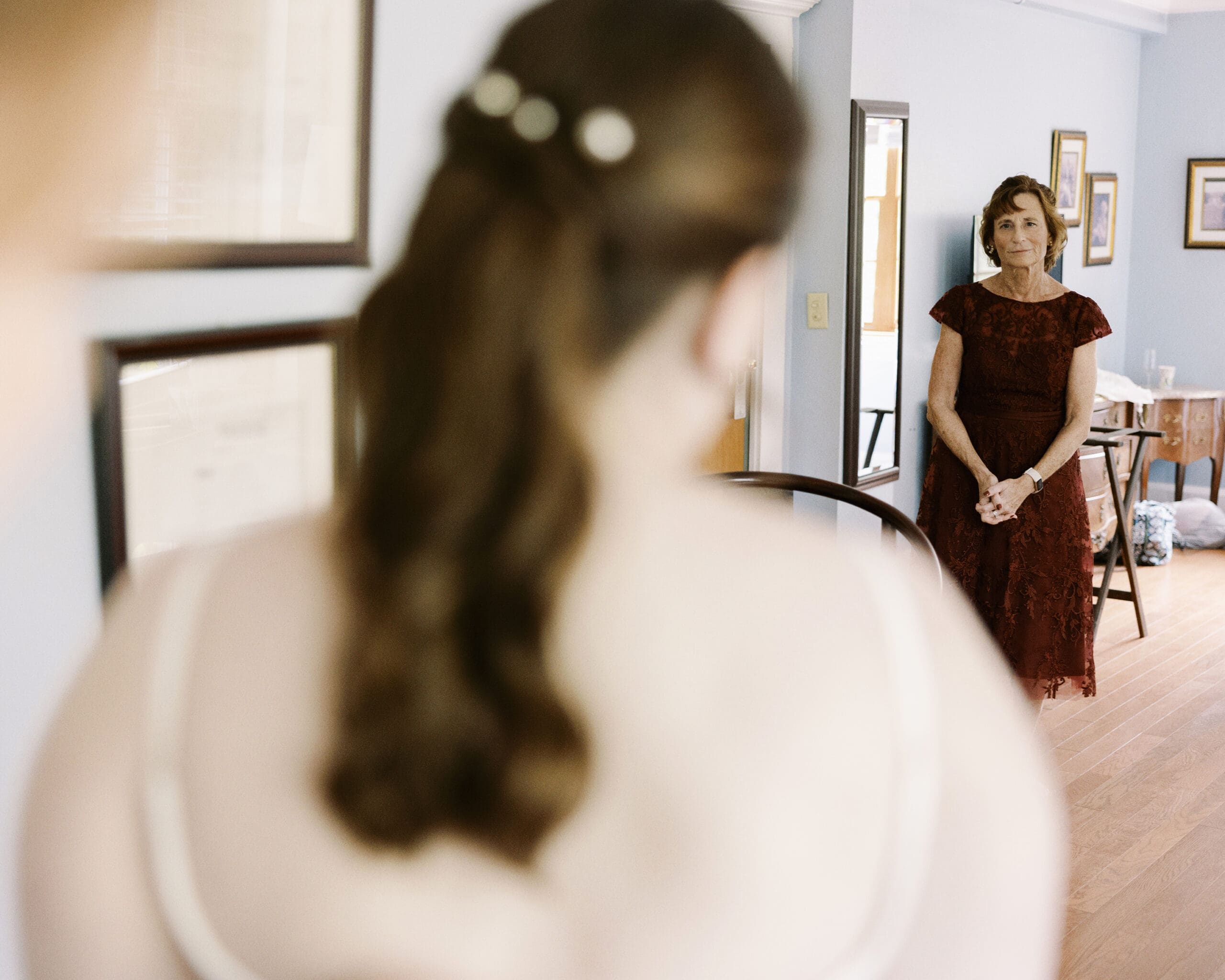 Bride's mom smiling at her while getting ready for wedding at the Outing lodge. 